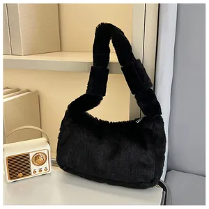 Close-up of soft black plush faux fur texture on a stylish women handbag and handle