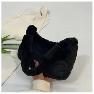 Close-up of black fluffy faux fur handbag showing soft texture and handle detail