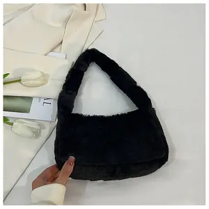Detail view of the soft black faux fur texture on a plush shoulder bag with integrated strap