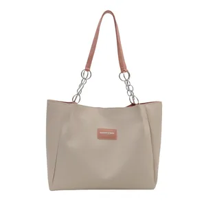 Large beige PU leather tote bag with pink handles and silver metal chain link details