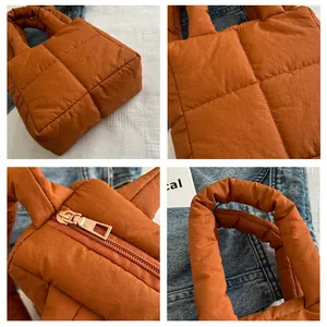 Vue détaillée du sac matelassé caramel avec fermeture éclair et poignées rembourrées