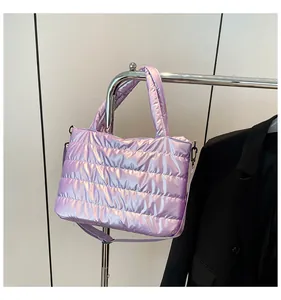Macro view of purple metallic quilted down bag with adjustable crossbody strap