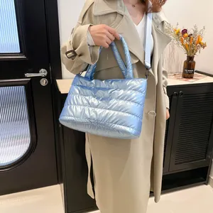 Metallic light blue quilted down shoulder bag with detachable strap and top handle
