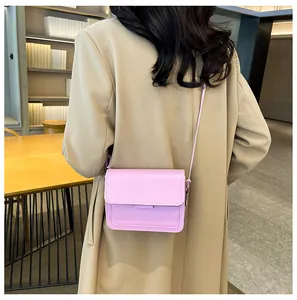 Model wearing a pink matte PU leather crossbody square bag with a flap closure detail