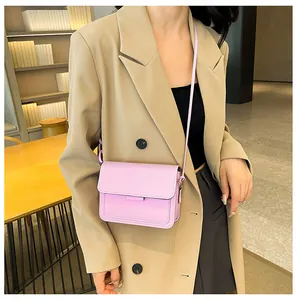 Close-up of lavender small square crossbody bag paired with a beige blazer outfit