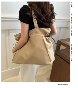 Detail of beige drawstring tote bag showing durable fabric and metal eyelet accents