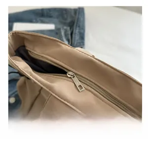 Detail of the smooth metal zipper closure on this khaki casual nylon tote bag
