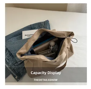 Top-down view of a spacious khaki tote bag interior showing daily commute essentials