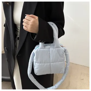 Détail du sac matelassé bleu ciel montrant les coutures carrées et le nylon