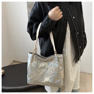 Detailed view of blue floral jacquard fabric on a large capacity tote bag for women