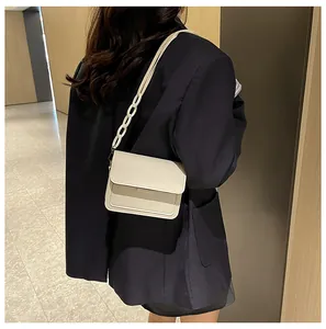 Detailed side view of off-white PU leather crossbody bag with matte chain strap