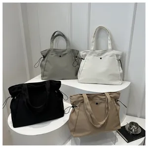 Collage of four minimalist tote bags in grey, white, black, and khaki with drawstring detail