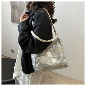 Detail of floral embroidery on large tote bag with metallic ring and white straps