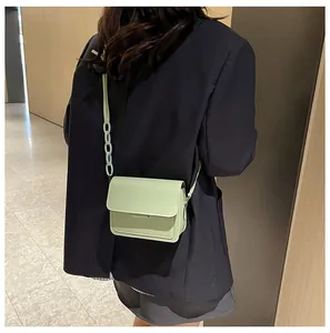 Detail of mint green crossbody bag with a stylish chunky matte chain strap for women