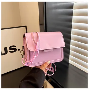 Detail view of pink PU leather flap bag with decorative thick chain and shoulder strap