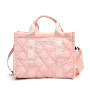 Lightweight pink quilted crossbody tote bag with soft fabric and durable handles