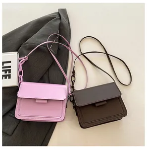 Detailed view of minimalist square flap bags in light purple and dark coffee matte leather