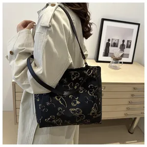 Lifestyle shot showing the large butterfly print tote bag worn on a woman's shoulder