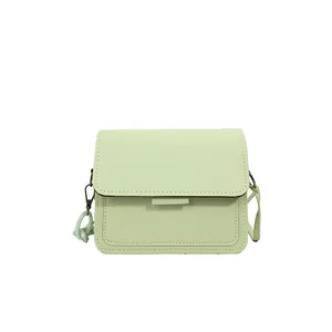 Minimalist light green square crossbody bag with flap closure and adjustable strap