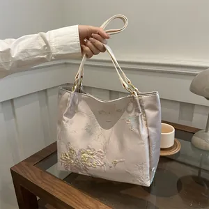 Pink floral jacquard tote bag with butterfly embroidery and golden hardware detail
