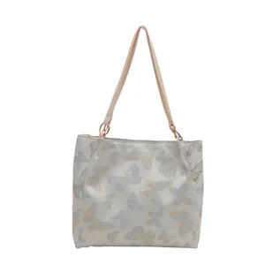 Large capacity tote bag with elegant blue butterfly print and golden metal ring straps