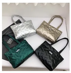 Detailed overhead view of quilted down tote bags in assorted metallic colors and textures