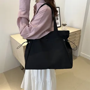 Minimalist large black tote bag for women showing spacious daily commute design style