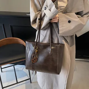 Vintage brown leather tote bag with large capacity and shoulder straps for daily commute