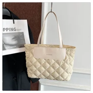 Detail of off-white quilted nylon tote bag with Fashion patch and elegant stitching