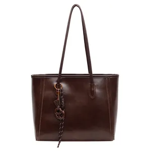 Retro dark brown leather tote bag for women with elegant metal ring and rope knot detail