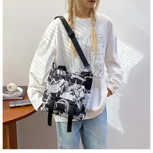 Detail of nylon messenger bag with graffiti print and dual buckle closures