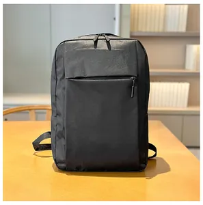 Detailed close-up of a black waterproof business backpack on a wooden desk background
