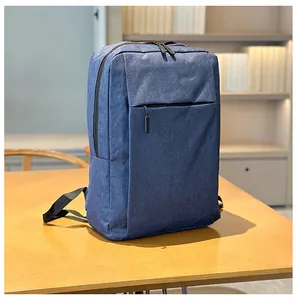 Detail of navy blue water-resistant fabric and sleek black metal zippers on business backpack