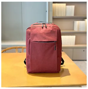 Close-up of a dark red business laptop backpack on a wooden desk for modern office use
