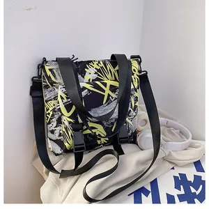 Detail of graffiti pattern nylon messenger bag with adjustable strap and plastic buckles