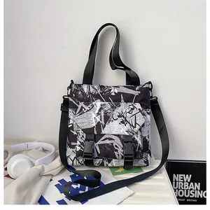 Close-up of nylon crossbody bag featuring street style graffiti and buckle pockets