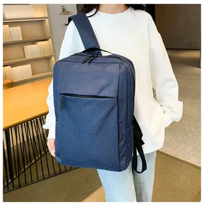 Close-up of a navy blue business backpack with denim texture shown in a library