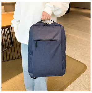 Close-up of the durable fabric texture and reinforced top handle of this navy business backpack