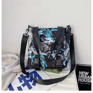 Detail of graffiti print nylon messenger bag showing plastic buckles and wide shoulder strap