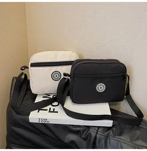 Detail of waterproof nylon crossbody bags with multi-pocket zippers and SPORT logo