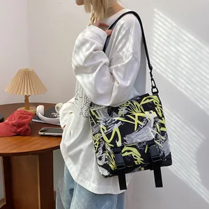 Large capacity nylon messenger bag featuring street graffiti print and buckle closure