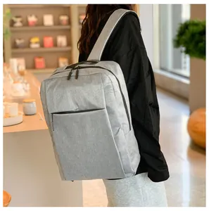 Close-up of a light grey minimalist backpack featuring smooth fabric and hidden front pockets