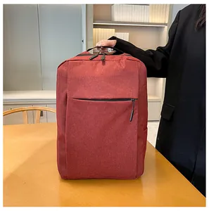 Detail of burgundy business backpack with texture fabric and front zipper on wood desk