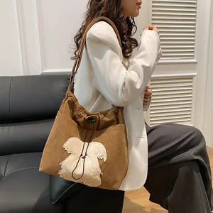 Brown corduroy tote bag with plush puppy embroidery shown as a stylish crossbody fit