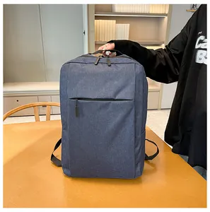 Business laptop backpack in dark blue nylon fabric placed on a wooden desk setup