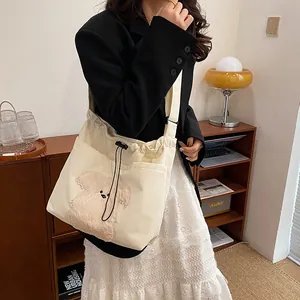 Chic corduroy tote bag in off-white featuring cute puppy embroidery and drawstring closure