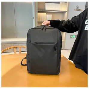Close-up of black business backpack showing front zipper pocket and top carry handle