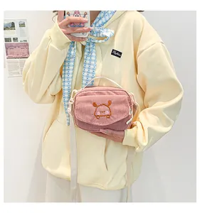 Vue détaillée du sac bandoulière en velours côtelé rose avec broderie animale mignonne