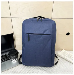 Navy blue laptop backpack on a wooden desk with laptop and coffee for office use
