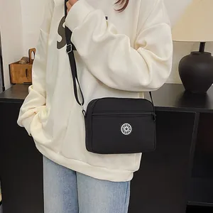 Casual black nylon crossbody bag for women with adjustable strap and sport logo detail